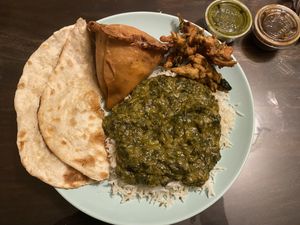 Garlic naan, saag, samosa, rice, pakoras, and the mint chutney and tamarind sauce for dipping.   at Taste of India in Rockaway Beach