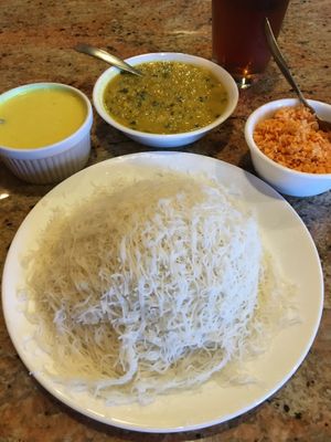 String Hoppers (white rice noodles). Served with Coconut Milk Curry (left), Dhal Curry (middle) & Coconut Sambol (right). It's like a stack of tortillas that you load, roll & eat. at House of Curry in Rosemount