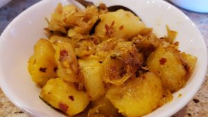 Alu haldi ($12). Potato onion curry. Great. at House of Curry in Rosemount