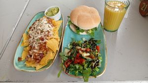 Nachos with guacamole, Chick'n burger, salad and orange juice at Thrive in Cambridge
