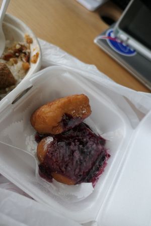 Fried Square of Dough topped with Powdered Sugar and Raspberry Sauce at Stango Cuisine in Champaign