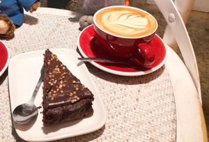 Oat flat white and cake. at Cafe 1802 in Rennes