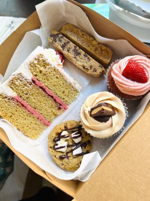 Mixed box with almond-raz cake, two kinds of biscotti, strawberry cupcake, peanut butter cup cupcake, s’mores cookie at Kindness Batters Vegan Bakery in Lake Worth