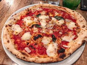 Saucy pizza. Paper thin, random plops of cheese and not many toppings.  at Fireflour Pizzeria in Bismarck