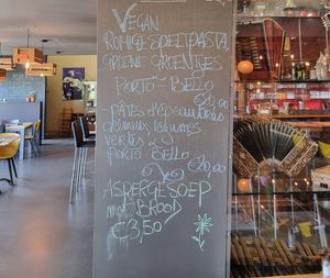 Vegan monthly special mentioned on chalk board  at Eetcafe 't Folk in Heuvelland