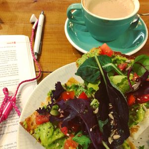 Avocado and tomato toast (toasted a con aguacate y tomate) and an oat milk latte. at Brunch Corner in Valencia