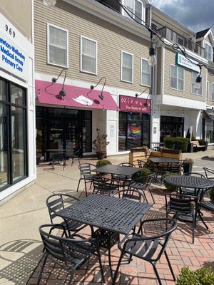Exterior with Pride flags at Nirvana Tea House & Cafe in Millis