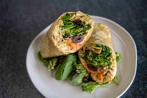 POWER PESTO WRAP
House-made hummus, red onions, spiralized carrots, kalamata olives, greens, red pepper, cucumber, quinoa, and pumpkin seed pesto on a spinach wrap.  at Antiox in Hagerstown