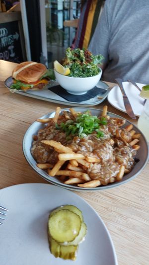 Poutine and Burger in the back at The Cider House in Vancouver