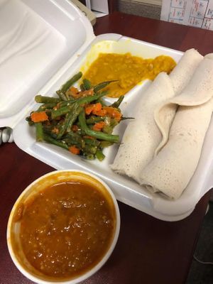 Lentil stew, green beans & carrots, split pea stew and injera. at Hana Ethiopian Cafe in Fredericton