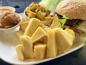 Red bean patty burger with breadfruit fries, hummus, and sides  at A l'Heure du Sud in Moorea