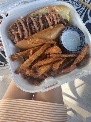 Philly cheesesteak with sweet potato fries at Organic Food Kings in Miami
