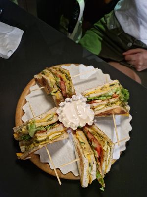 Club sandwich with hummus, vegetables, vegan cheese at Oasis Cafè in Treviso