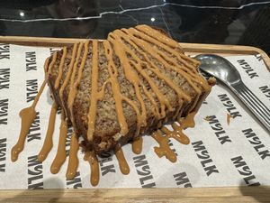 Banana bread with pb drizzle   at MYLK in Doha