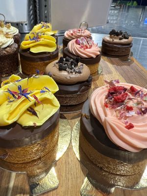 Cake topped with chocolate ganache and cream. Flavours differ at Taart in Utrecht