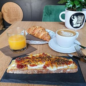 Brie Cheese, cranberry jam and orange peels on toasted brown bread  at R&B in Ljubljana