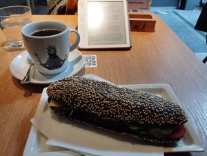 Vegan charcoal bread with vegan cheese, hummus, paprika and pickles. And a cup of filter coffee for 5 euro at R&B in Ljubljana