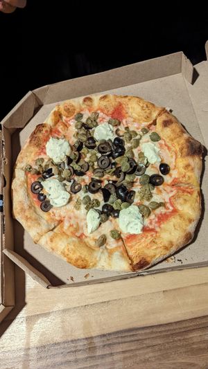 Pizza with olives and capers at Herbívoro- Chapinero in Bogota