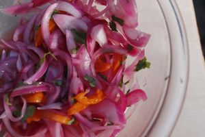 Salsa Criolla

Pickled red onions with aji amarillo, cilantro and lime juice. Topped on most dishes  at TUME in Orlando