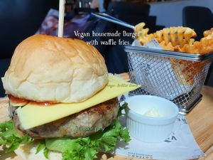 Vegan housemade Burger with waffle fries at VIBE Coffee & Plant-Based Food in Bangkok