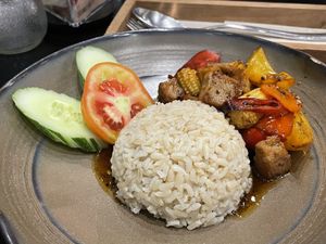 Vegan stir fried soy chicken in organic black pepper on rice, 129 baht  at VIBE Coffee & Plant-Based Food in Bangkok
