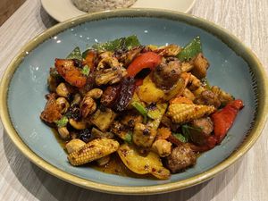 Vegan sautéed plant chicken with cashews in aroma chilli oil (169 baht) with brown rice (45 baht)  at VIBE Coffee & Plant-Based Food in Bangkok