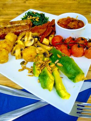 our go BIG vegan breakfast, mushroom based sausage, vacon, vine tomatoes, Cajun spiced beans, crispy potatoes, avocado, spinach, mushrooms & toast at Daisy's  in Torquay