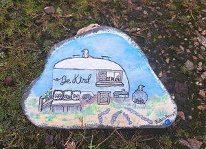 The caravan painted on a pebble at Be Kind The Vegan Coffee Caravan in Hayle