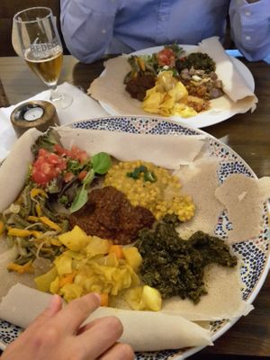 Front: Mixed vegan plate for 2, back: regular mixed plate (with meat) for 1 at Fasika in Cologne