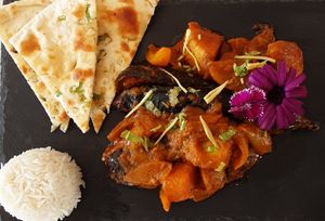 Charcoal cooked eggplant with white rice and garlic naan. at Spices in Frigiliana