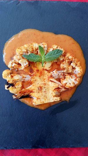 Coliflower cooked in charcoal oven seve with cherry tomatoes souce. at Spices in Frigiliana