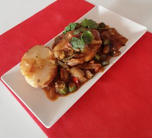 Okra bhuna cooked with ,charcoal cooked onion ,fresh tomato serve with jacket potato cooked in ,charcoal. at Spices in Frigiliana