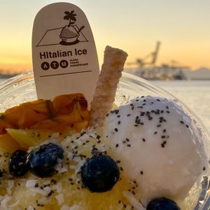 Pineapple Ice bowl with coconut Frozert, blueberries, and coconut flakes on the waterfront. at HItalian Ice in Honolulu
