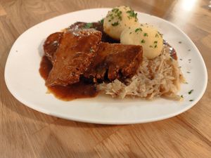 Caraway roast with sweet sauerkraut and potato dumplings at Velani in Vienna