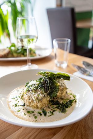 Wild garlic dumplings in a creamy cheese sauce at Velani in Vienna