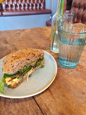Sandwich with pickled red onion, mushrooms, pesto, fennel, chili hummus, lettuce, spinach, arugula and more. It tasted amazing! at Café Parforce in Klampenborg