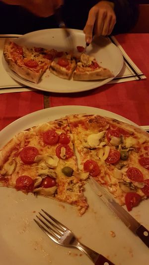 Vega pizza with vegan cheese mushrooms ans cherry tomato at Pizzeria Napoli in Kamnik
