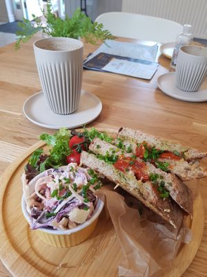 Vegan cheese, tomato and pesto toasted sandwich with an oat latte. at Happyccino in Wimborne
