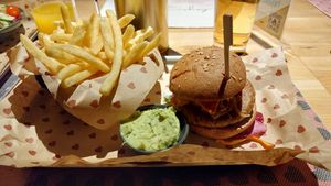 Burger with fries and guacamole dip. at Burgerheart in Ingolstadt