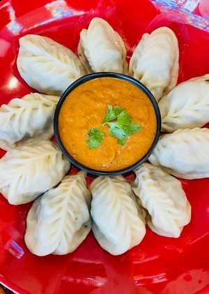Steam Vegan MOMO with tomato,sesame and schewan pepper sauce at Momo Central in Melbourne