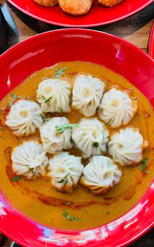 Vegan steamed MOMO with tomato and soybeans paste spicy sauce  at Momo Central in Melbourne