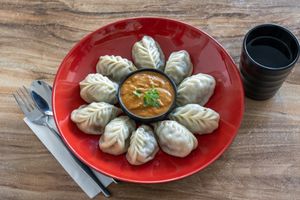 steam MOMO with sesame and schewan and tomato sauce at Momo Central in Melbourne