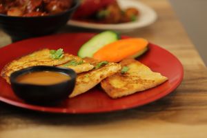 Vegan Savoury Lentil Pan Cake with special sauce at Momo Central in Melbourne