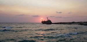 Ghostly shipwreck by sunset at Oniro By The Sea in Paphos