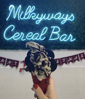 Vegan vanilla with cookie butter and Oreos mixed in. Oreos and Hershey’s syrup on top with a red velvet cone  at MilkyWays Ice Cream & Cereal Bar in Coram