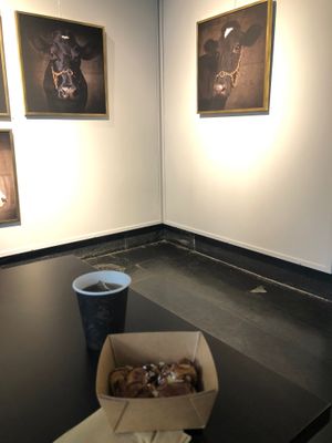 Cinnamon rolls in front of photoart.  at Station Grön in Raettvik