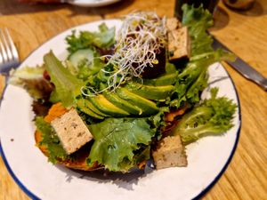 Vegan toast with pumpkin, avocado, smoked tofu and salad at Kitchen Paris in Paris