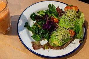 vegan toast of the day - avocado, pesto, salad and edible flowers at Kitchen Paris in Paris