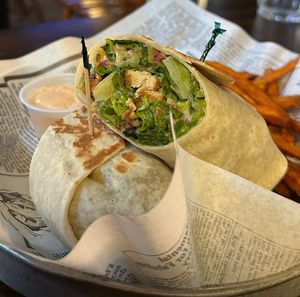 Vegan ceaser wrap with beyond chicken strips in it and simulated bacon bits with a side of sweet potato fries and vegan dip at Shepherd's Pub in Elora