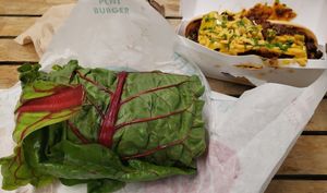 Spicy Chik'n Funguy burger in a swiss chard wrap and Chili N' Cheese Sausage at PLNT Burger in Wynnewood